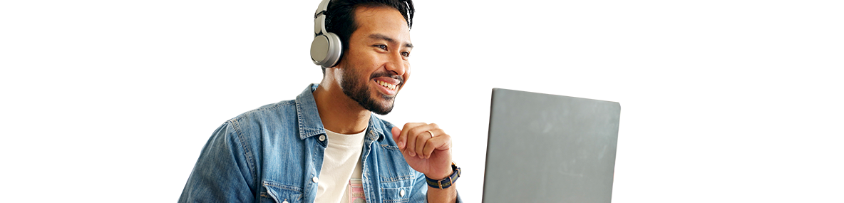 smiling man wearing headphones making a video call on a computer